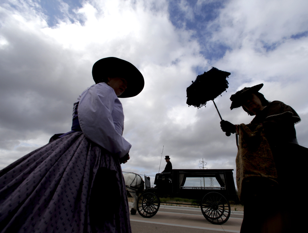 Civil War re-enactors wait near a horse-drawn hearse used to transport the Civil War-era remains of Army Sgt. Charles Schroeter on Thursday in San Diego, Calif. Scores of veterans from past wars, from Vietnam to Afghanistan attended the ceremony, including two fellow Medal of Honor recipients.