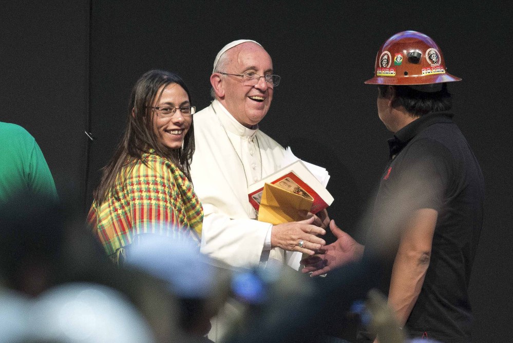 Pope Francis greets a participant in the second World Meeting of Popular Movements in Santa Cruz on Thursday, where he apologized for sins against indigenous peoples.