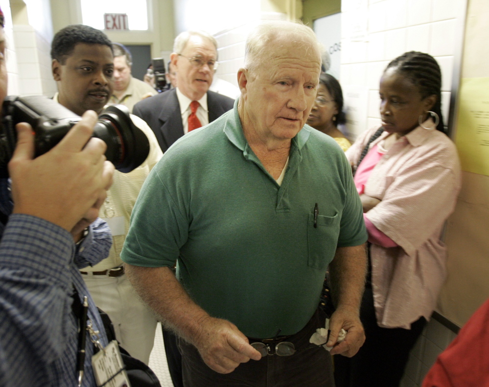 Retired Alabama state trooper James Bonard Fowler, 73, center, is seen in 2007 as he leaves the Sheriff’s Office in Marion, Ala., after turning himself in.