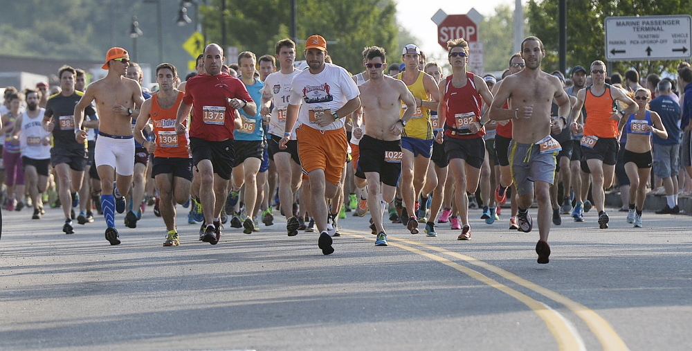 Runners take off at the start of the Old Port Half Marathon on Saturday
