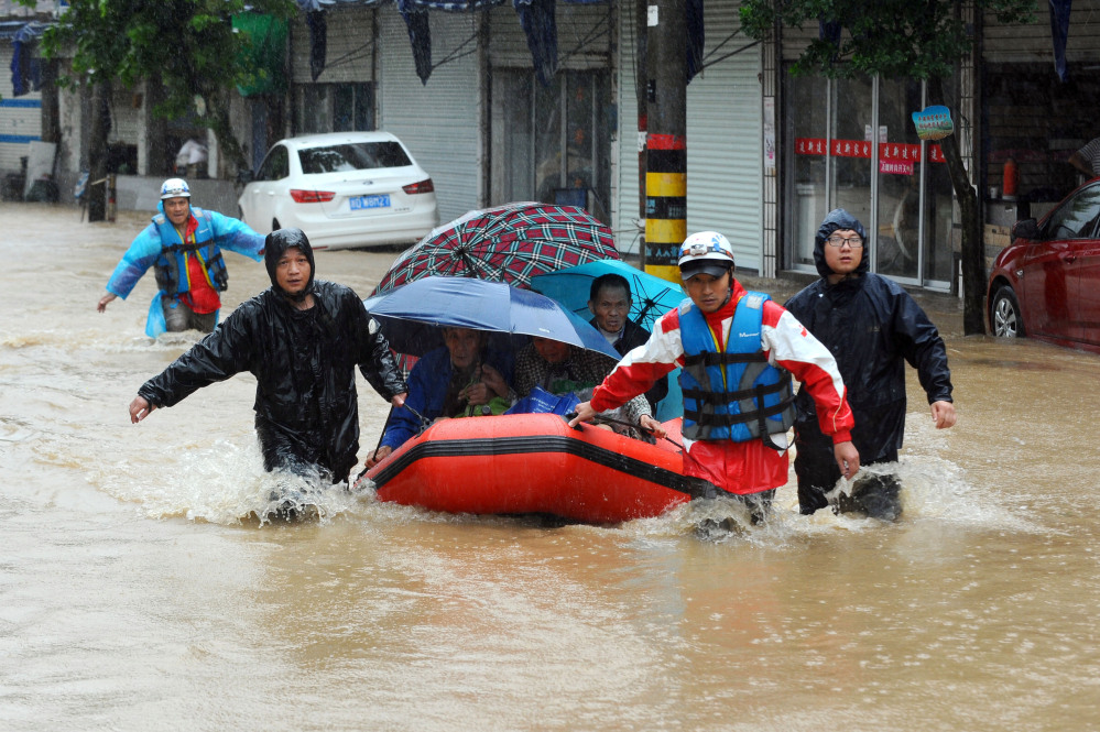 Rescuers use an inflatable boat to evacuate residents from a neighborhood flooded by heavy rains from Typhoon Chan-hom in Shaoxing in eastern China’s Zhejiang province Saturday. Some 1.1 million people were evacuated from coastal areas of Zhejiang and more than 46,000 in neighboring Jiangsu province ahead of the storm, the official Xinhua News Agency reported.