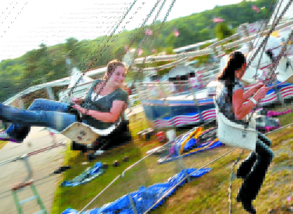 Krista Rogers, left, and Megan Miville, spin on the Trapeze Swings at the Skowhegan State Fair last year. This year’s fair will run from Aug. 13 to Aug. 22.
