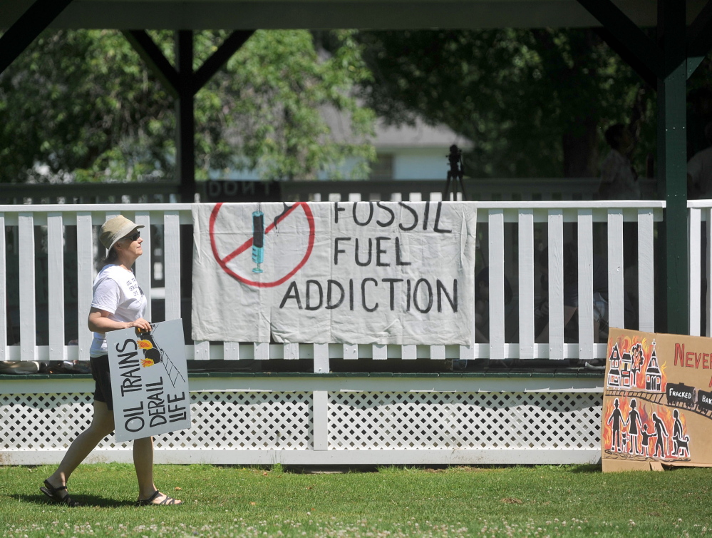 A woman arrives on Saturday at Veteran’s Memorial Park in Fairfield for a protest against oil trains.