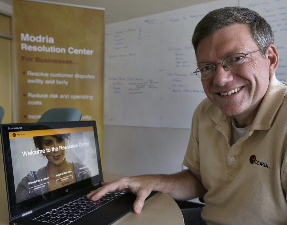 Colin Rule, CEO of Modria, poses with the Modria resolution software on his laptop at his company’s  headquarters in San Jose, Calif.