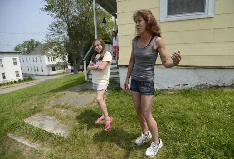 Kristine Sampson, who lives at the corner of Clifford and George streets in Biddeford, across the street from where Sunday’s “swatting” incident happened, describes on Monday what she saw. With her is her daughter Skyler Verrill, 11, and visible to the left of Verrill is the apartment building at 41 Clifford St.