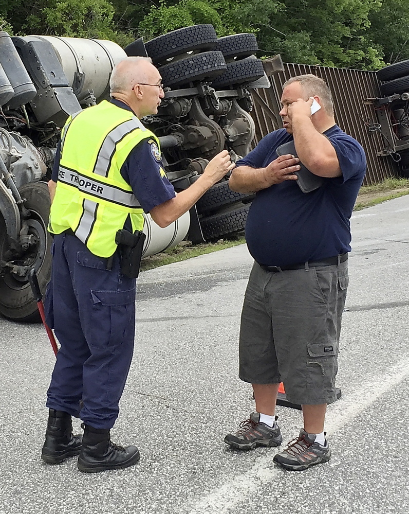 Cpl. Charles P. Granger, left, gives instructions to Marc Besner of Quebec, driver of the tractor-trailer.