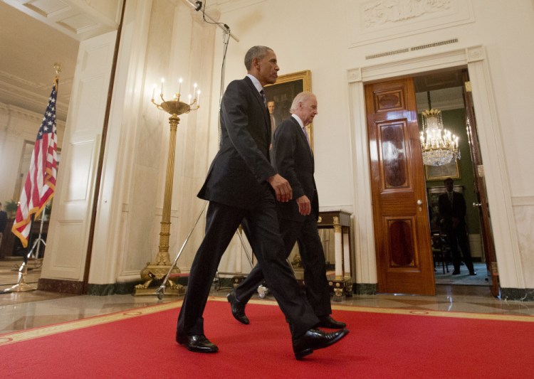 President Barack Obama walks with Vice President Joe Biden after delivering remarks in the East Room of the White House in Washington on Tuesday after an Iran nuclear deal was reached.