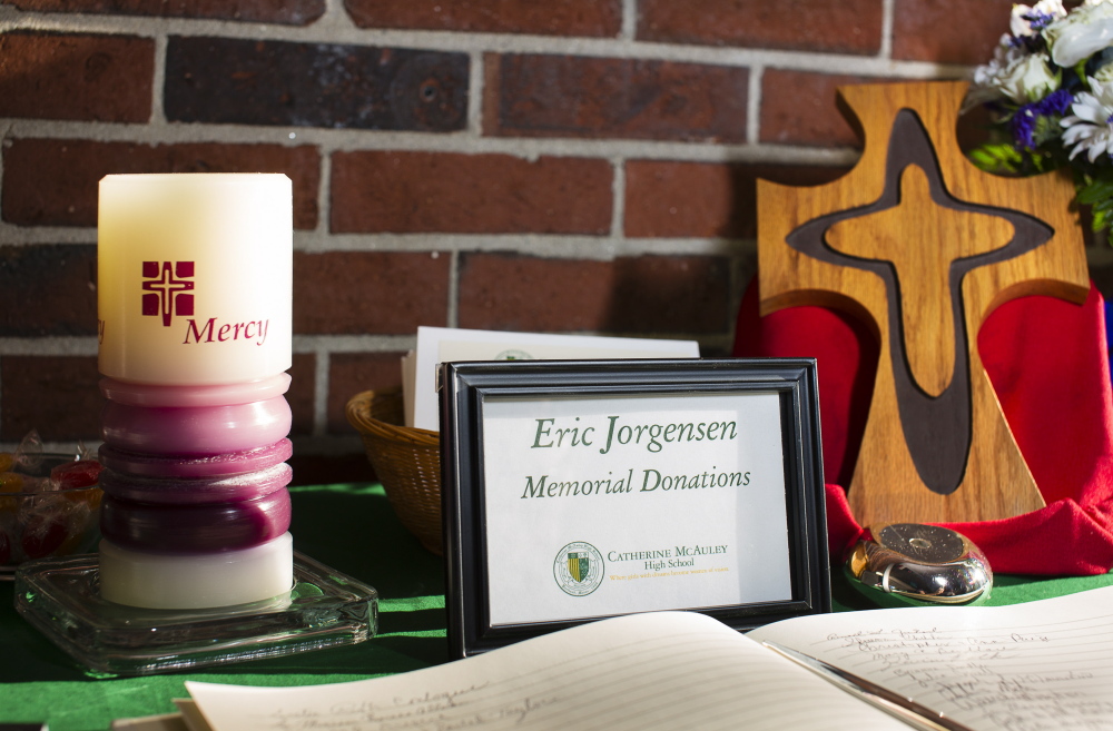 A memorial fund in the name of Eric Jorgensen is promoted in the main lobby of Catherine McAuley High School, where a memorial service was held in his honor on Wednesday.
Carl D. Walsh/Staff Photographer