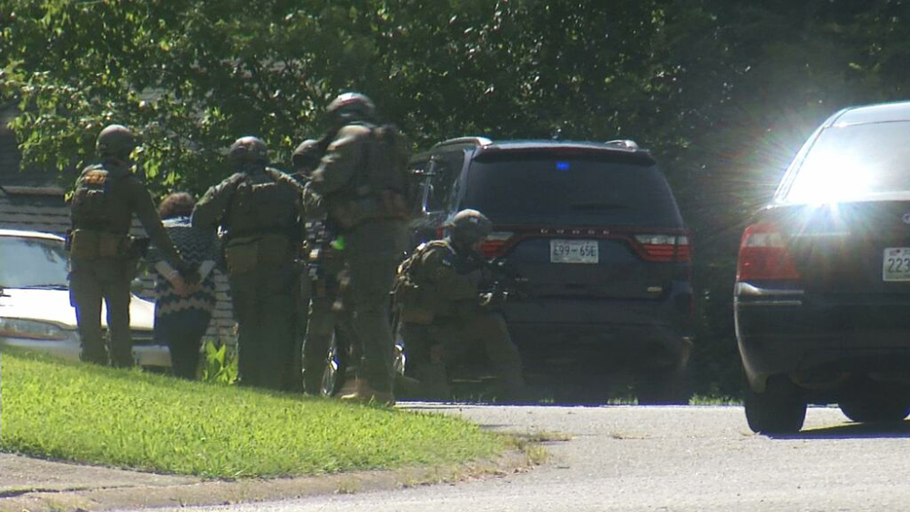 In this frame from video, law enforcement officers detain a woman as they surround a house in Hixson, Tenn., on Thursday after gunman opened fire on two military sites before being killed. Officers with guns drawn swarmed what was believed to be Abdulazeez’s house, and two women were led away in handcuffs.
