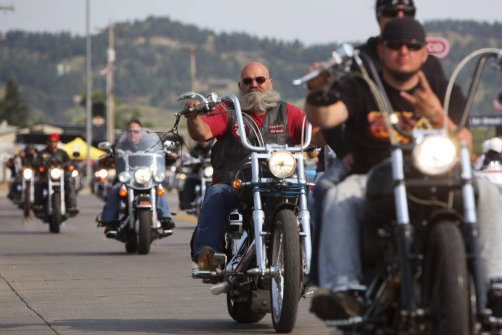 FILE - In this Aug. 4, 2014, file photo, motorcyclists ride down a street in Sturgis, S.D., for the opening day of the 74th Annual Motorcycle Rally. Organizers expect 1 million people for the weeklong 75th Sturgis rally which begins Aug. 3, 2015. (AP Photo/Toby Brusseau, File)