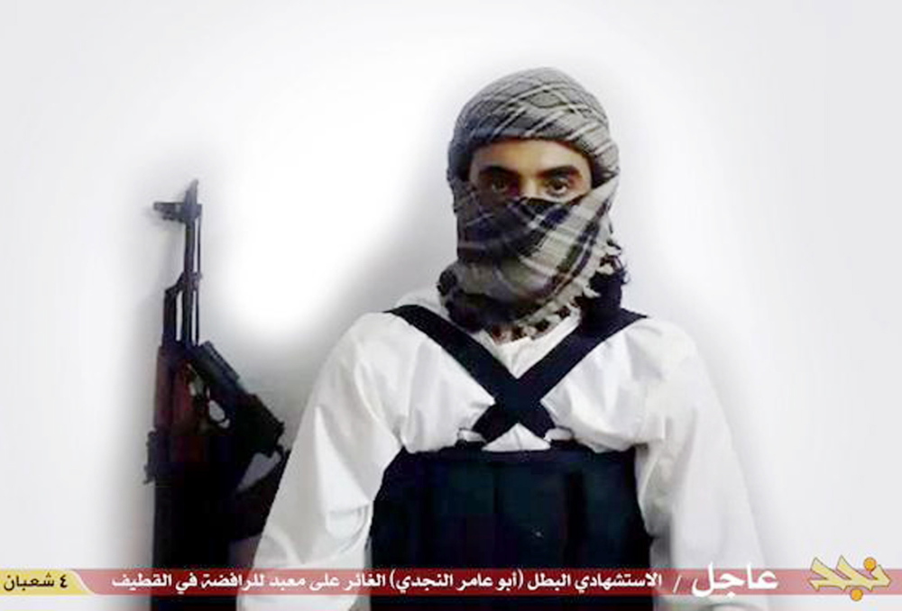 The Islamic State’s use of social medial is broadening the terrorist group’s outreach, warns the Department of Homeland Security. A file image posted on May 23 purports to show a suicide bomber,  with the Arabic bar below reading: “Urgent: The heroic martyr Abu Amer al-Najdi, the attacker of the (Shiite) temple in Qatif,”  for which the Islamic State’s radio station claimed responsibility
The Associated Press