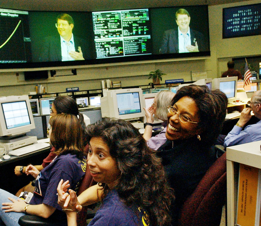 Claudia Alexander, right, project manager for Galileo, works in the mission control room in Pasadena, Calif., along with engineer Nagin Cox, center, and others in 2003.
