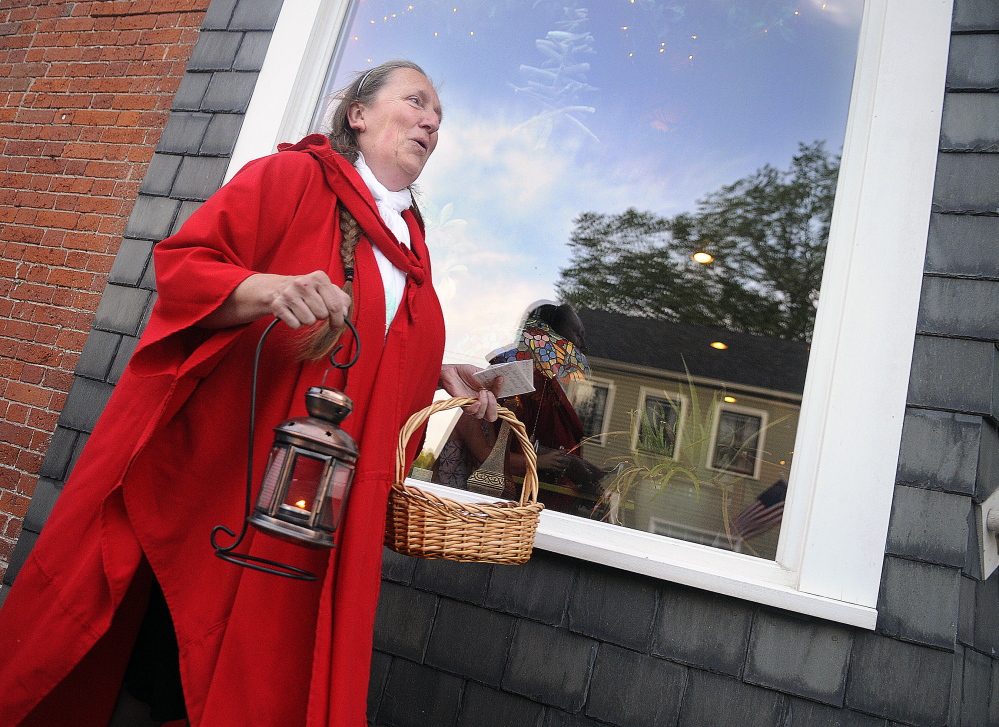 Kelly Henderson leads a Red Cloak Tour of historic and haunted spots in Hallowell. Stories of hauntings appeal to younger folks, while older people like history.