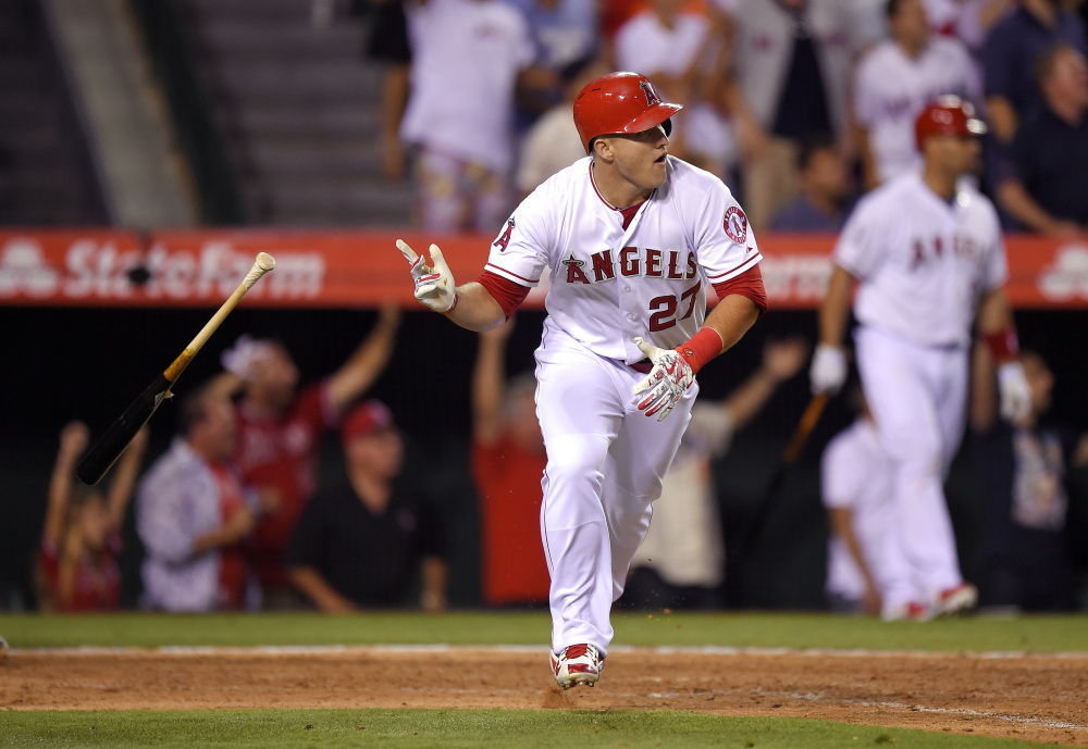 Mike Trout tosses his bat after hitting a home run with two outs in the bottom of the ninth inning Friday to give the Angels a 1-0 win over the Red Sox.