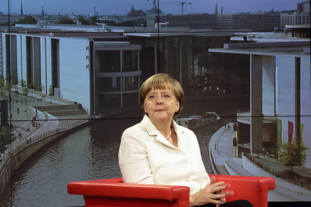 Chancellor Angela Merkel says she is pushing for talks on terms of the bailout deal on Greece to move as quickly as possible because it’s important that “the country gets back on both feet quickly.”