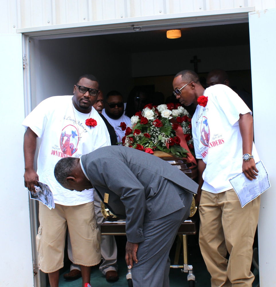 Pallbearers bring out the casket containing the body of Stonewall, Miss., resident Jonathan Sanders following his funeral services Saturday, July 18, 2015, at the Family Life Center in Quitman, Miss.