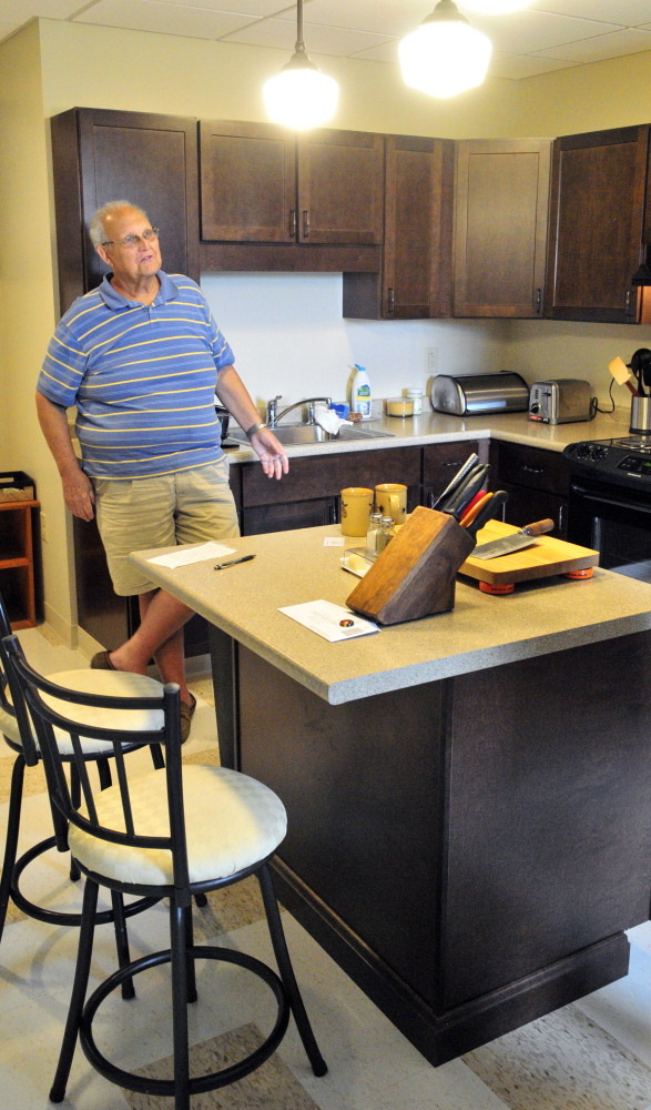 Jim Whitten shows off his new apartment in the Cony Flatiron Senior Residence.