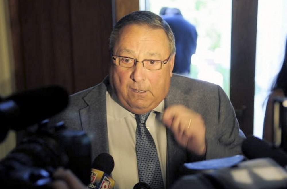 Gov. Paul LePage talks to a reporter about his veto messages as he leaves the State House in Augusta last Thursday.