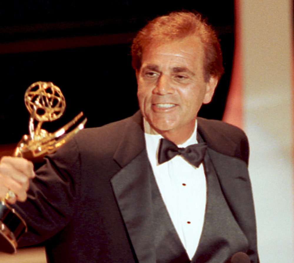 Alex Rocco holds up his Emmy award for best supporting actor in a television comedy series for his role in “The Famous Teddy Z.”