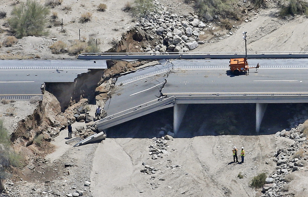 The collapsed section of Interstate 10 in Desert Center, Calif., shows the gully eroded by Sunday’s pounding flash food. The highway is the key link between Los Angeles and Phoenix, every day carrying on average 27,000 vehicles in either direction.