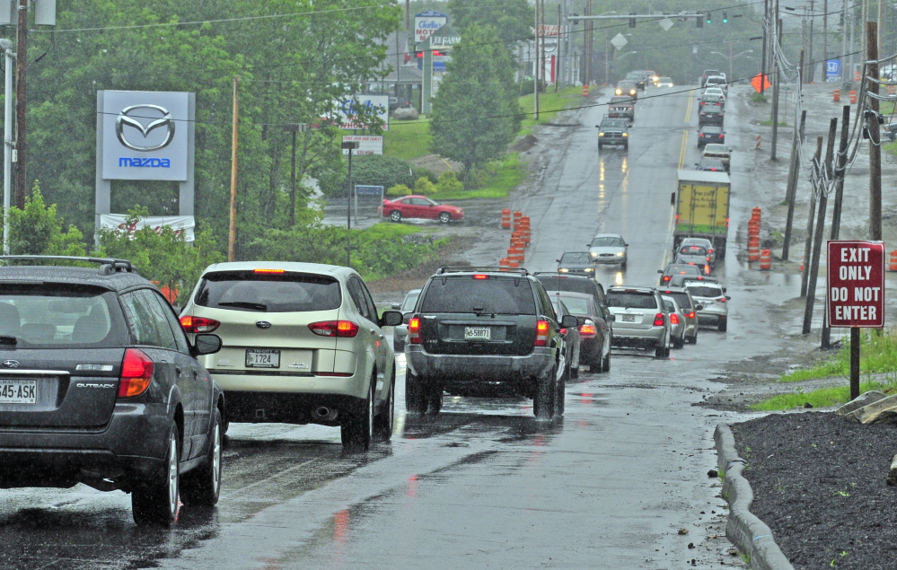 Traffic heads eastbound on Western Avenue near the intersection of Woodside Road in Augusta, where Karen Nightingale hit a pothole while riding her motorcycle and died nine days later.