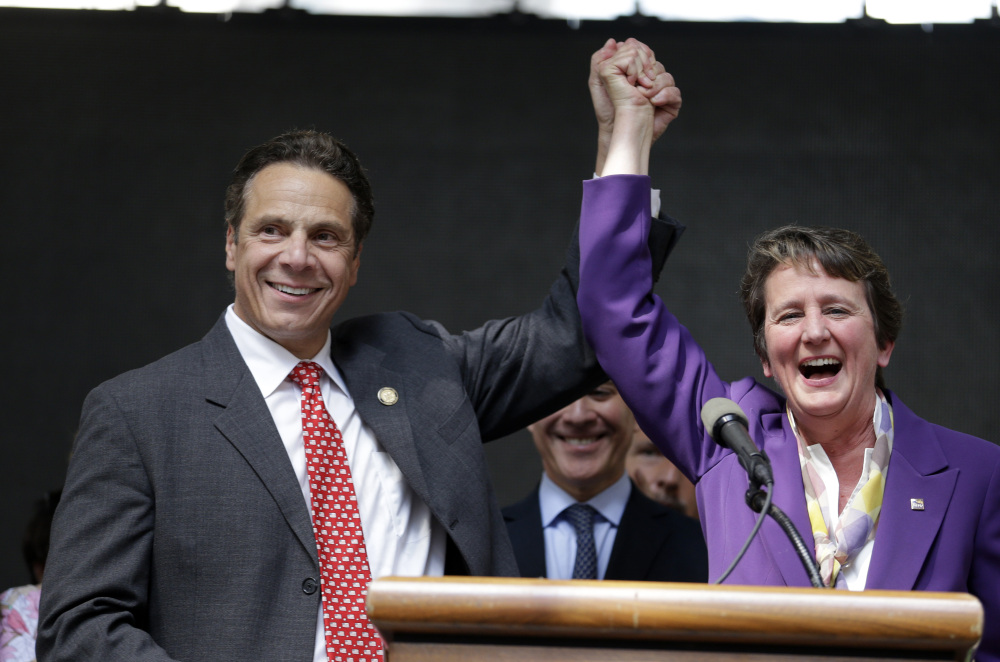New York Gov. Andrew Cuomo and Service Employees International Union President Mary Kay Henry rally after a state board endorsed a wage hike for fast-food workers.