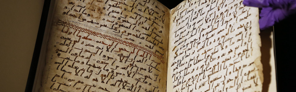 A university assistant shows fragments of an old Quran at the University in Birmingham in central England.