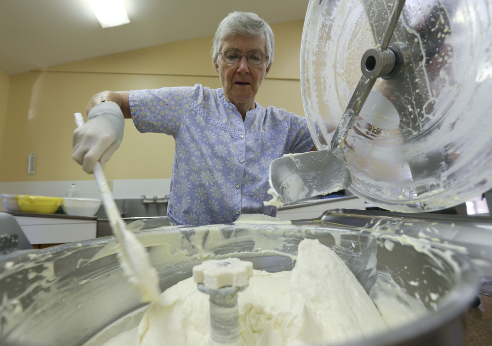 Sister Patricia mixes cheesecake batter  in Cambridge, N.Y.  “You make 220 decisions on whether the cakes are baked. ... You need to know the look of each flavor,” she says.