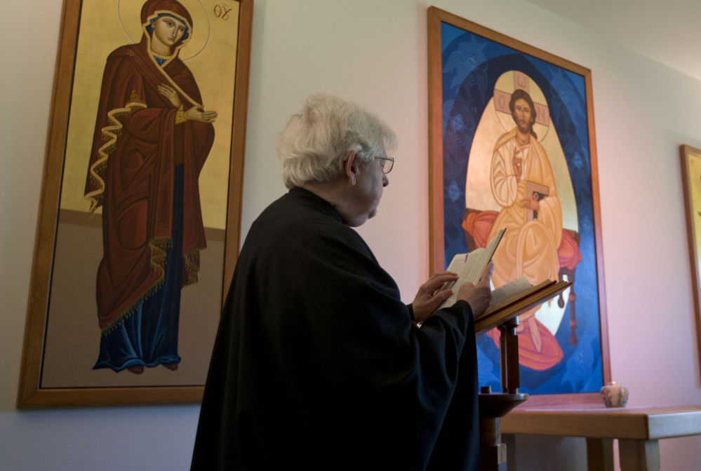 Sister Rebecca reads during a morning prayer service. The nuns of New Skete lead cloistered lives marked by prayer, contemplation and baking high-end cheesecakes.