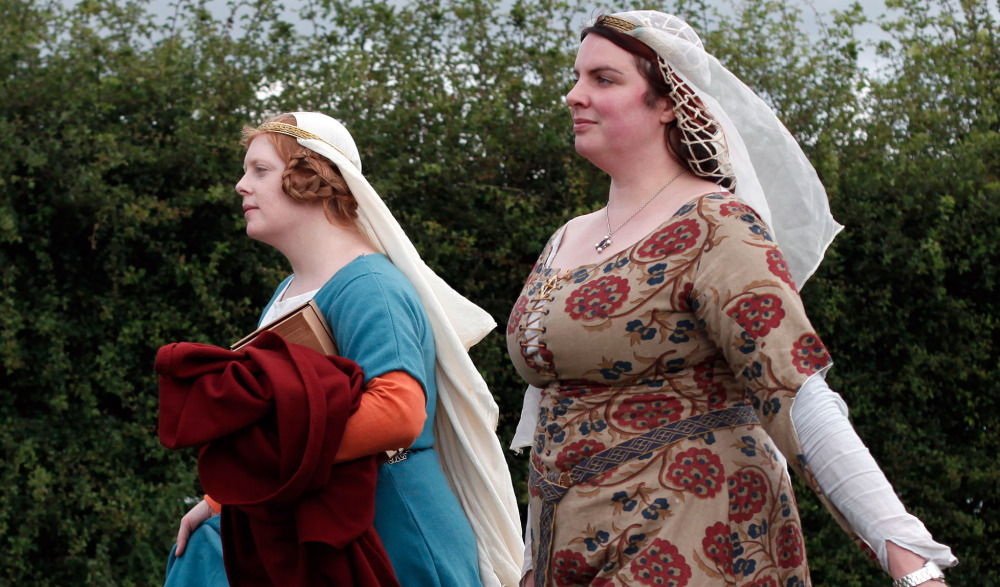 Women wear medieval garb during the re-enactment of the Battle of Agincourt Saturday.