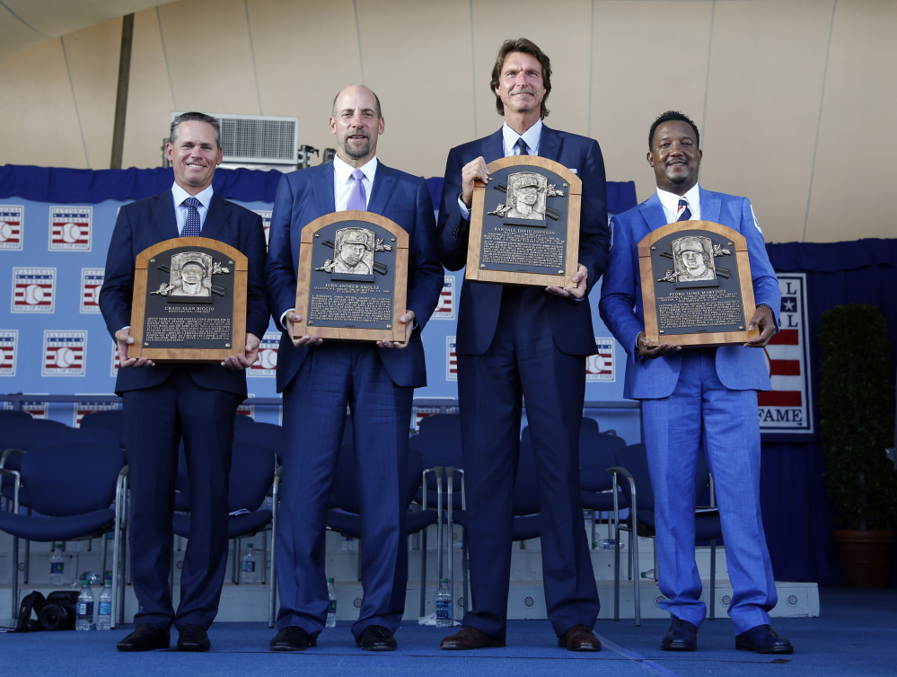 Newly inducted National Baseball Hall of Famers  from left: Craig Biggio, John Smoltz, Randy Johnson and Pedro Martinez hold their plaques after an induction ceremony.