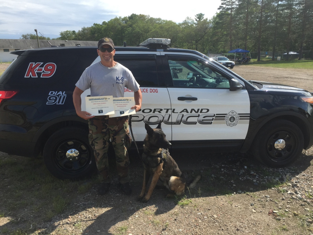 Portland Police Officer Christian Stickney and his canine partner, Blaze, after winning first-place overall in a competition in Raynham, Massachusetts, on Friday.