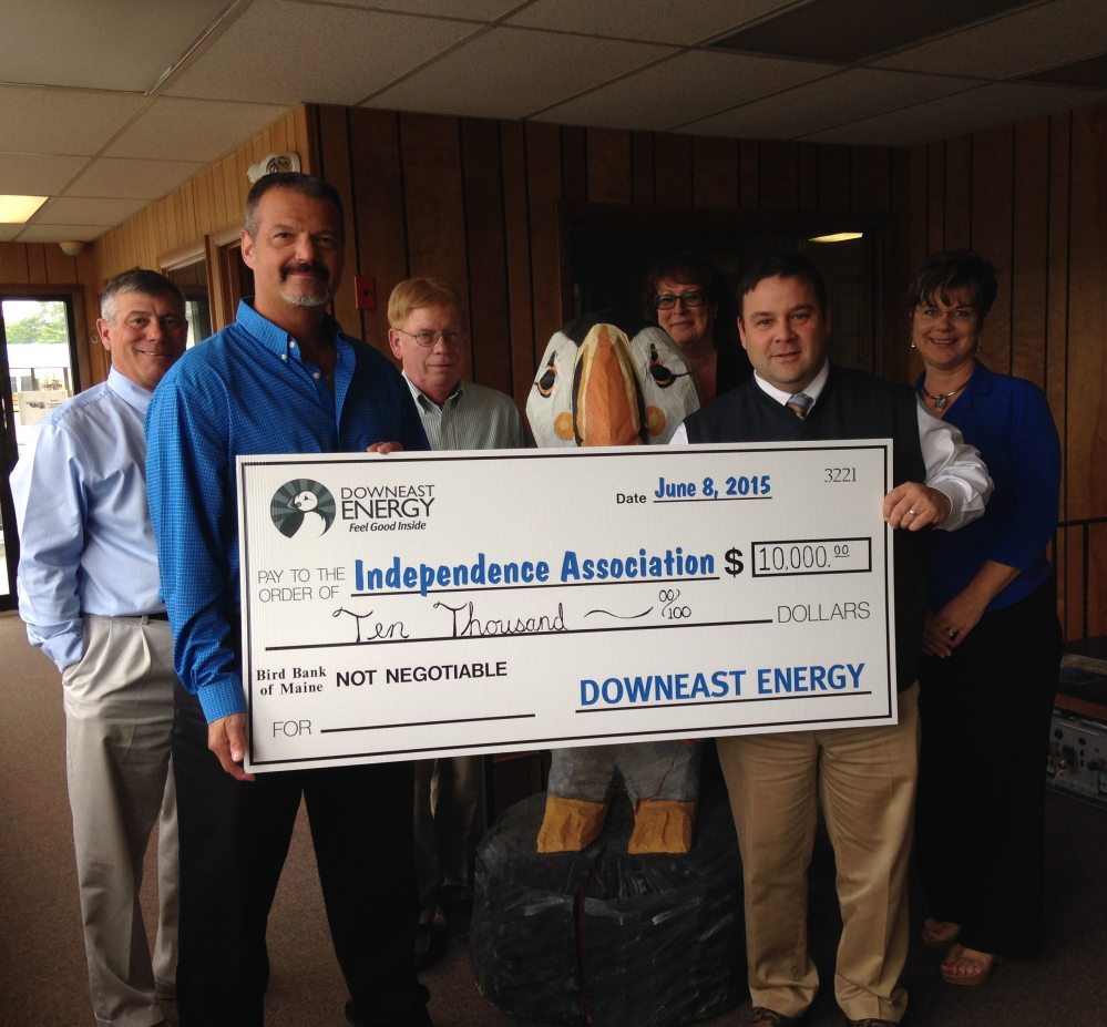 Representatives from Downeast Energy present a check to Independence Association, a Brunswick nonprofit that serves people with disabilities.