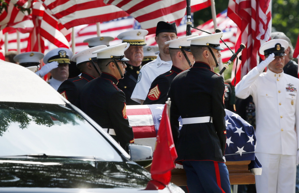 Marine pallbearers carry the casket of Marine Gunnery Sgt. Thomas Sullivan into a funeral service at Holy Cross Church in Springfield, Mass., on Monday. Sullivan was one of five service members slain by a gunman in Chattanooga on July 16.