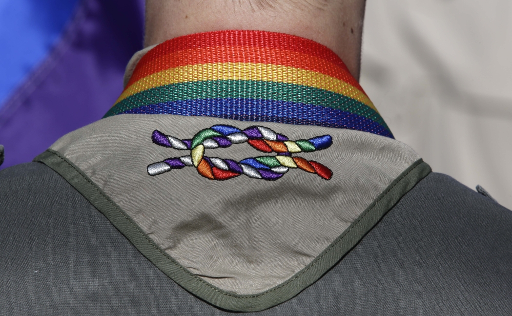 A Boy Scout takes part in Salt Lake City’s annual gay pride parade in 2014. By allowing individual units to continue to ban gay leaders, the Boy Scouts of America is taking the same approach it did to racial discrimination during much of the 20th century.