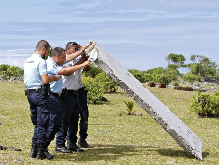 On July 30, French police inspect the wing piece found on Reunion Island that is now confirmed to be the "flaperon" of Malaysian Flight 370. The Associated Press