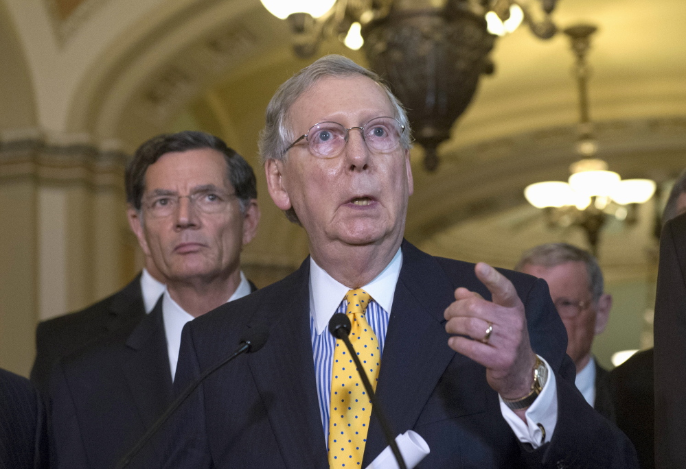 Senate Majority Leader Mitch McConnell, R-Ky., speaks during a news conference, accompanied by Sen. John Barrasso, R-Wyo., earlier this month as Congress struggled with a difficult agenda. That struggle is expected to resume when Congress returns after its summer vacation.