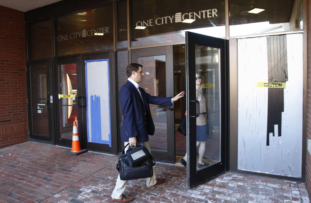 Two doors at One City Center in Portland were damaged early Friday when a man fired four shots from a high-powered pellet gun at an unarmed security guard. Joel Page/Staff Photographer