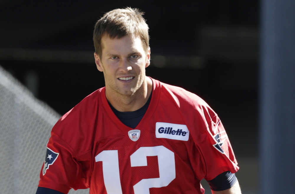 New England Patriots quarterback Tom Brady heads to the practice field during an NFL football training camp in Foxborough, Mass., Friday, July 31, 2015. (AP Photo/Charles Krupa)