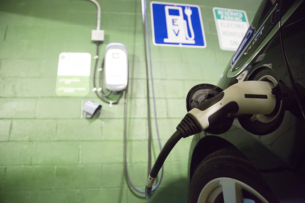A Chevrolet Volt is plugged in to an electric vehicle charger, one of seven installed in Portland so far.