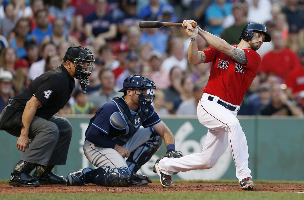 Boston catcher Blake Swihart hits a two-run single in the first inning of Friday night’s game. Swihart also doubled in the eighth inning, then scored on a wild pitch to give Boston a 7-5 lead.