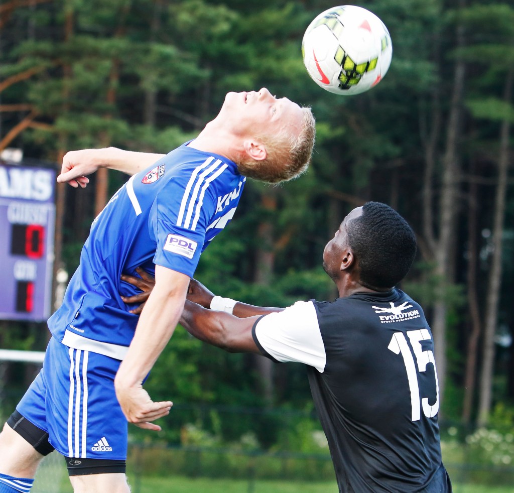 Peabo Knoth heads the ball away from Real Boston’s Ado Kawuba. Knoth and his Portland Phoenix teammates open the Premier Development League playoffs with a home game July 21 at Yarmouth High. Jill Brady/Staff Photographer