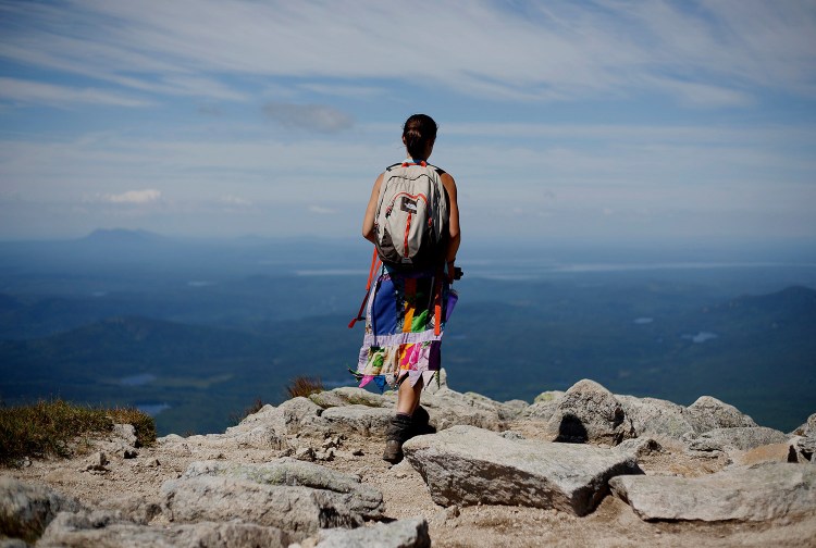 Sarah Morse of North Berwick, who hiked the Appalachian Trail last year using the trail name "Leap Frog," takes in the view near the summit of Mount Katahdin. This year, Baxter State Park is issuing permits to hikers who want to end the trek on Katahdin.