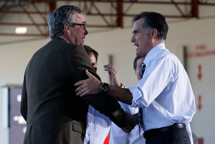 In this file photo Republican presidential candidate and former Massachusetts Gov. Mitt Romney campaigns with former Florida Gov. Jeb Bush in Tampa, Fla., Wednesday, Oct. 31, 2012. The Associated Press