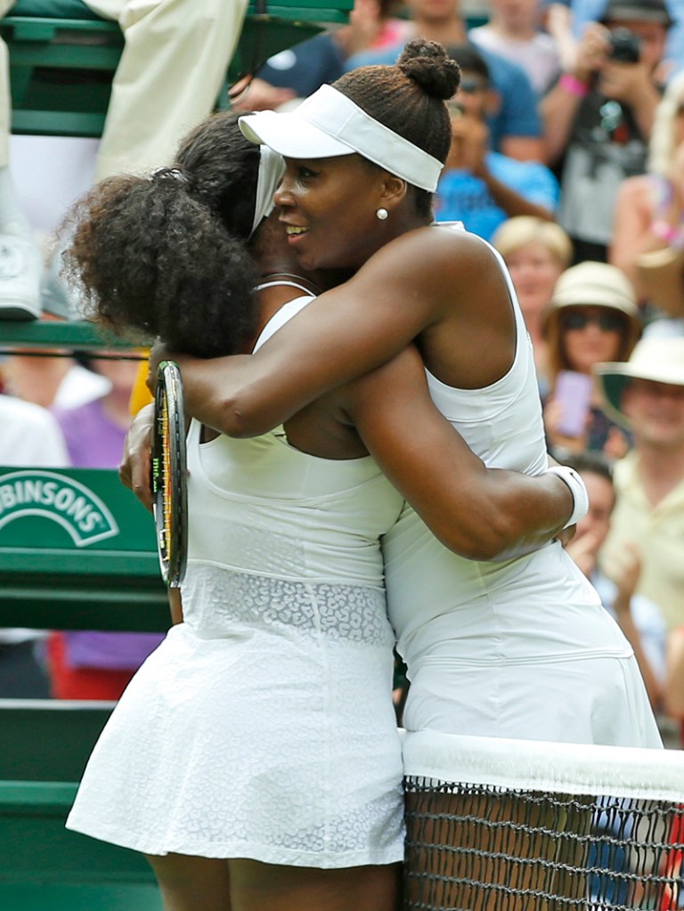 Sisters Serena and Venus Williams embrace after their match Monday. Serena won 6-4, 6-3. Both sisters have won Wimbledon five times, but Serena also has a total of 20 Grand Slam titles. The Associated Press