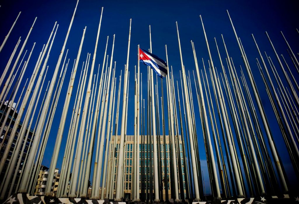 A Cuban flag flies among empty flag poles near the U.S. Interests Section building in Havana on Sunday. The Associated Press