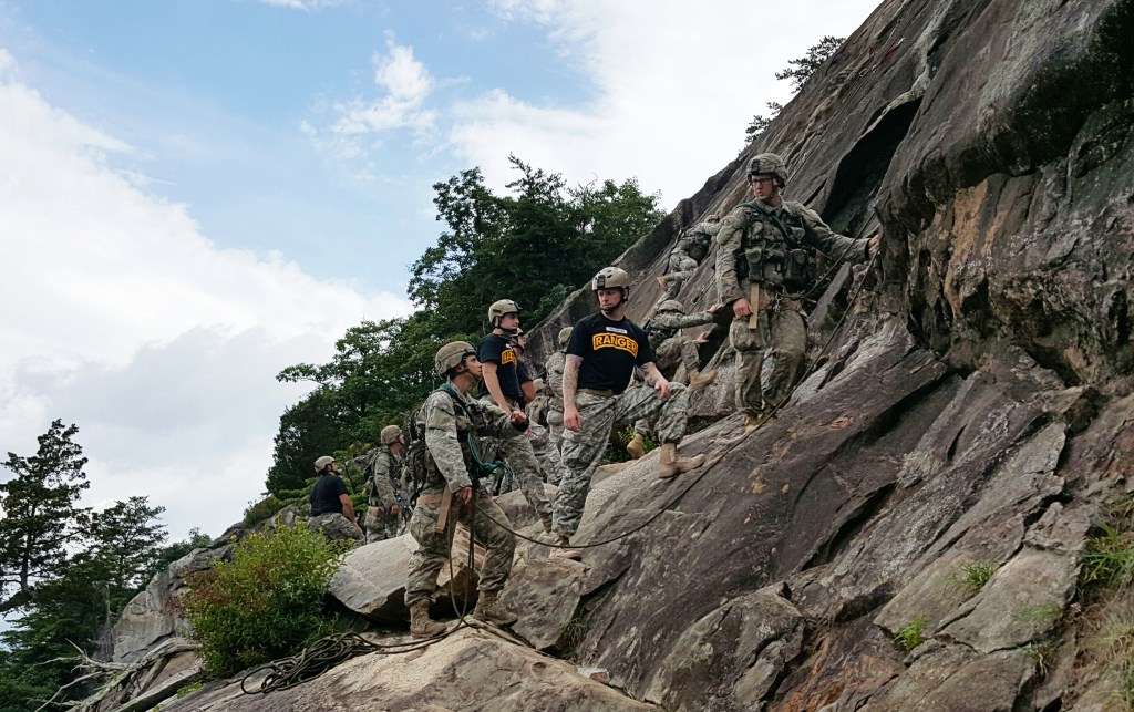 A two-person team of Ranger students, including a woman at left, receives guidance from a Ranger instructor on Mount Yonah in northern Georgia. Washington Post photo by Dan Lamothe