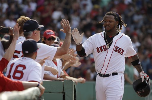 Hanley Ramirez is welcomed to the Red Sox dugout after hitting a home run last season. This year he's being told to concentrate less on slugging, more on athleticism. The Associated Press