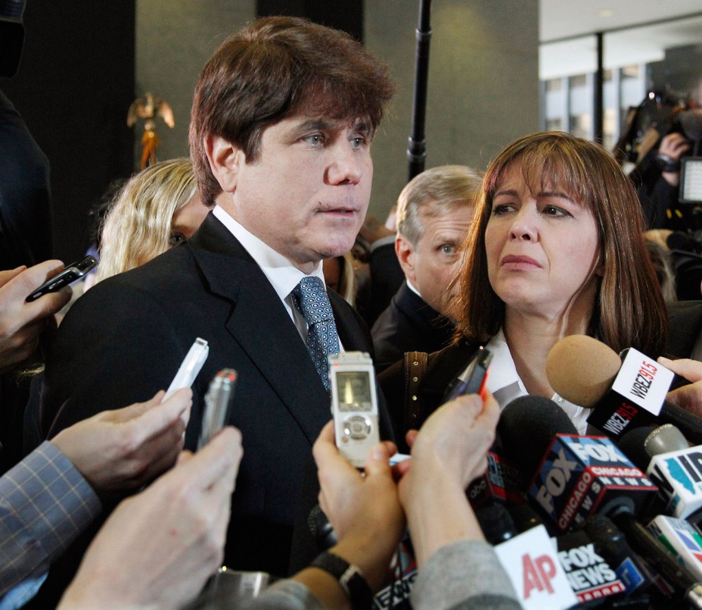 Former Illinois Gov. Rod Blagojevich, left, speaks to reporters as his wife, Patti, listens at the federal building in Chicago after Blagojevich was sentenced to 14 years on 18 corruption counts. The 7th U.S. Circuit Court of Appeals on Tuesday overturned some of the corruption convictions.