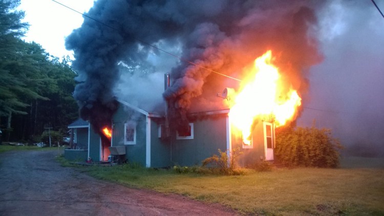 Fire rages through a home on Post Road in Bowdoinham on Thursday morning.